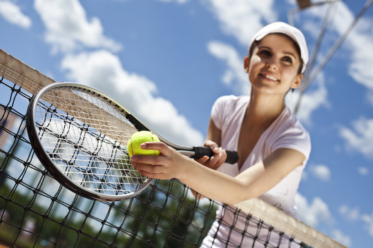 Girl playing tennis on the court