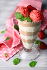 Tasty chocolate mousse with sorbet on wooden table