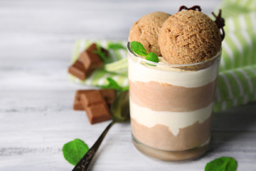 Tasty chocolate mousse with sorbet on wooden table