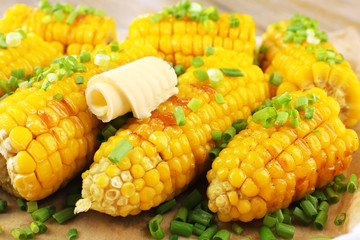 Grilled corn cobs on table, close-up