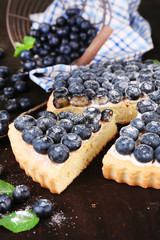 Tasty homemade pie with blueberries on wooden table