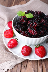 Bowl of blackberries and plate of strawberries
