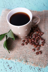 Polka dot mug of coffee beans isolated on white