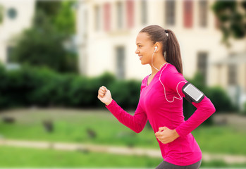 smiling young woman running outdoors