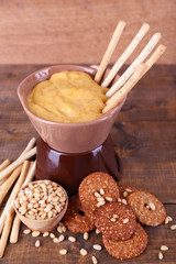 Fondue, spice, biscuits on wooden background