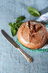 Fresh baked bread and fresh basil, on wooden background