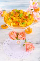 Apricot dessert in glass on table close-up