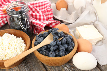 Fresh blueberries and milk products on wooden table