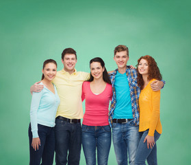 group of smiling teenagers over green board