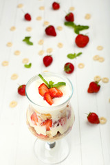 Natural yogurt with fresh berries on wooden table