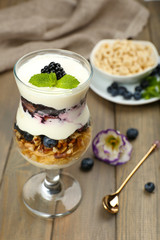Natural yogurt with fresh berries on wooden table