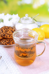Cup of tea on table on bright background
