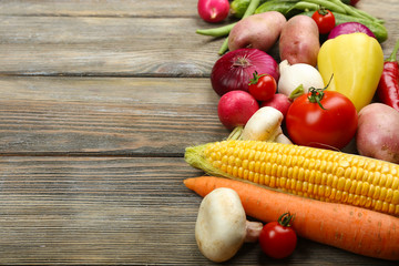 Summer frame with fresh organic vegetables on wooden background