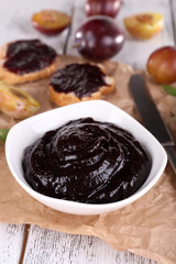 Plum jam, slices of bread with plum jam and fresh plums in