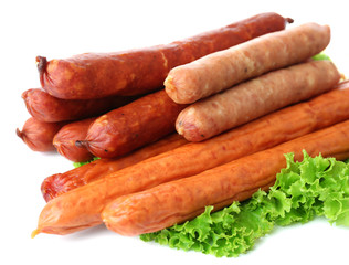 Assortment of thin sausages  with lettuce salad leaves,