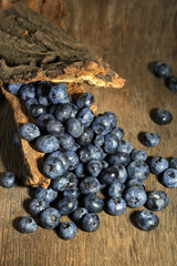 Tasty ripe blueberries, on wooden background