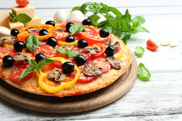 Delicious pizza served on wooden table