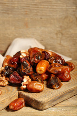 Tasty dates fruits on wooden table