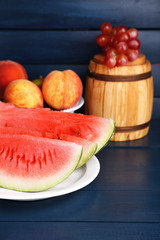 Composition of ripe watermelon, fruits, pink wine in glass and