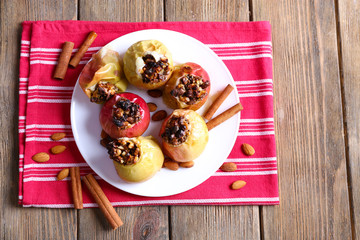 Baked apples on plate on table close up