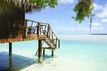 Tropical cabin over waters edge, Cook Islands