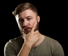 Fototapeta na wymiar Portrait of handsome man with beard on black background