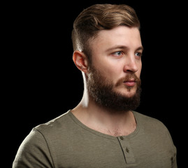 Fototapeta premium Portrait of handsome man with beard on black background