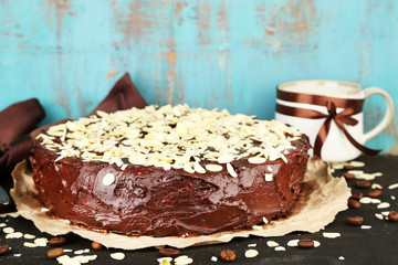Tasty chocolate cake with almond, on old wooden table
