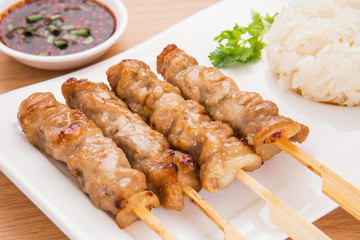 Grilled pork and sticky rice on plate, Thai food style