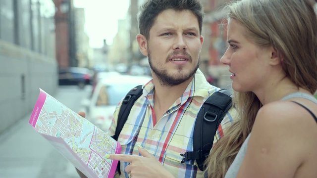 Young couple with a city map during a sightseeing