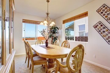 Beautiful carved wood dining table set in bright room