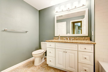 White bathroom vanity cabinet with granite top