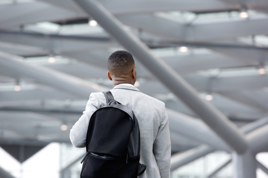 Black man standing in airport with bag