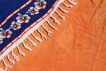 Summer background orange towel blue sarong