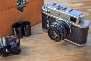 Old camera on wooden background