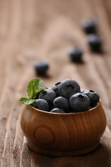 Fresh blueberries in a wooden bowl