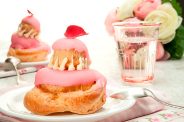 Vanilla eclairs with pink frosting