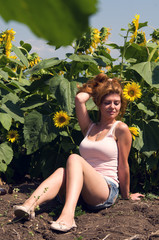 Young woman in sunflowers