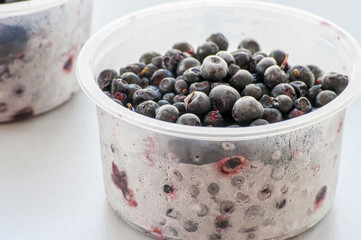 Frozen blueberries close up on light background