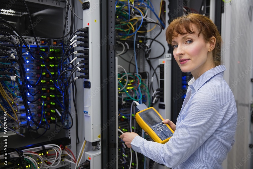 Aufkleber technician using digital cable analyzer on server