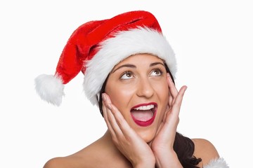 Surprised woman wearing santa hat