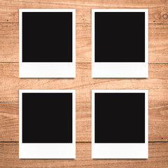 blank photo frame on wood background