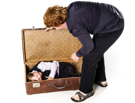 Two brothers playing with retro suitcase