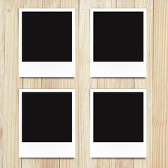 blank photo frame on wood background