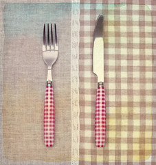 Fork and knife on napkin. Vintage retro style. Paper textured.