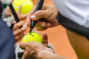 Tennis player signs autograph after win - obrazy, fototapety, plakaty