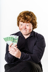 Happy red-haired boy with money