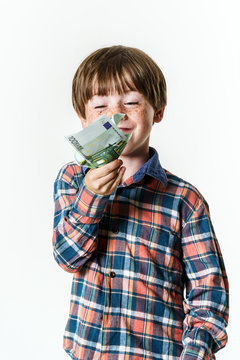Happy red-haired boy with money