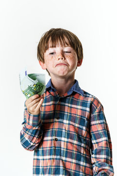 Happy red-haired boy with money