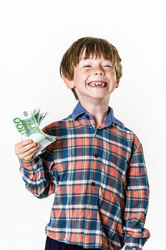 Happy red-haired boy with money